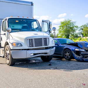 Collision between a semi-truck and a car on the highway, representing a semi-truck accident - Fenstersheib Law Group